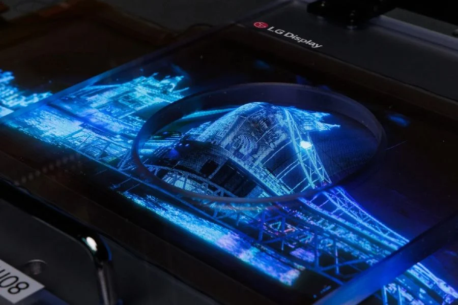 Écran OLED transparent de LG Display affichant une image lumineuse et détaillée d'un pont illuminé en bleu. L'écran présente une haute résolution et une transparence partielle, mettant en valeur la technologie avancée d'affichage.